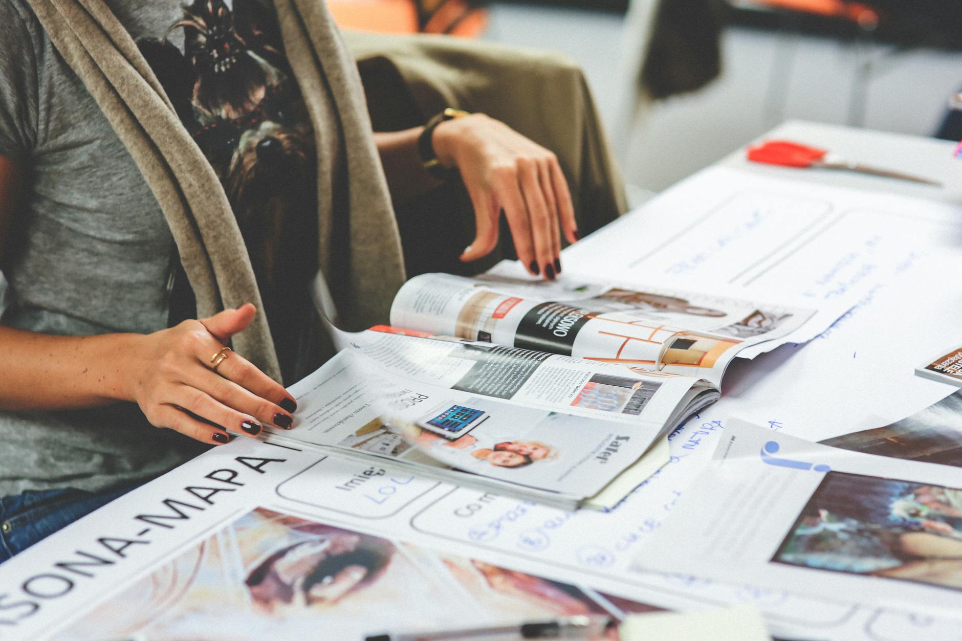 person looking through magazines